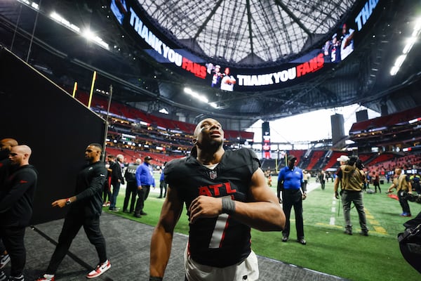 Falcons running back Bijan Robinson looks at fans as he leaves the field Sunday.