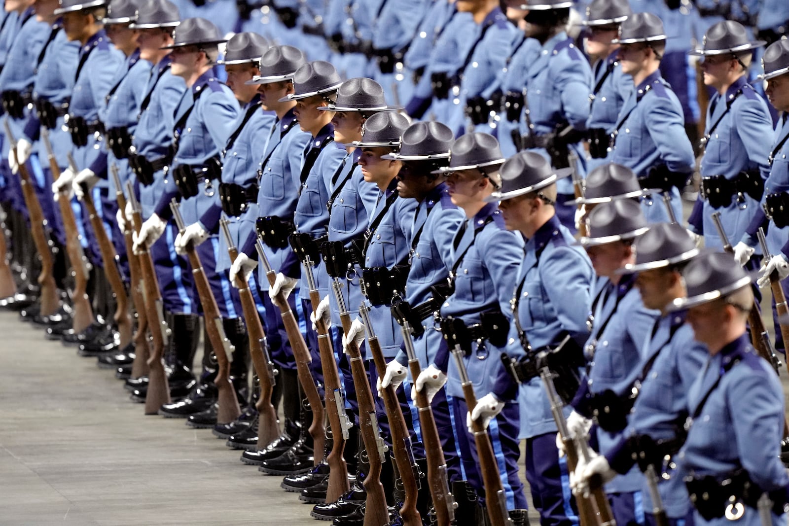 Members of the 90th Recruit Training Group of the Massachusetts State Police stand in formation, Wednesday, Oct. 9, 2024, during swearing in ceremonies at the DCU Center, in Worcester, Mass. (AP Photo/Steven Senne)