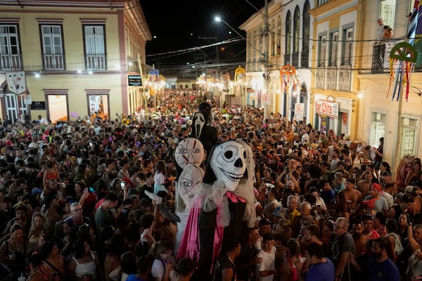 Revelers gather in a street during Carnival in Sao Luiz do Paraitinga, Brazil, Sunday, March 2, 2025. (AP Photo/Andre Penner)