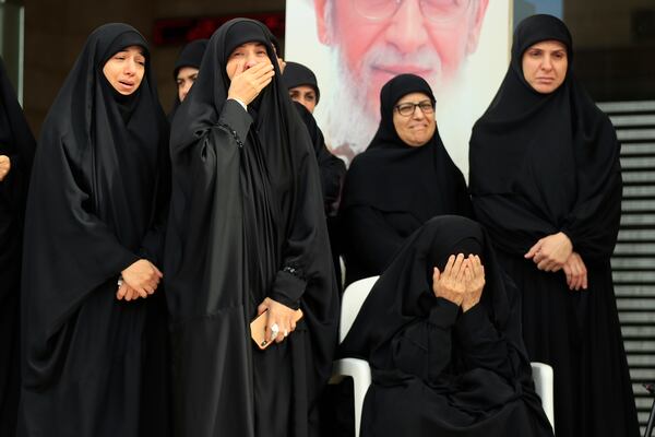 Relatives of Hezbollah's chief spokesman Mohammed Afif who was killed in an Israeli airstrike in Beirut on Sunday, mourn during his funeral in the southern port city of Sidon, Lebanon, Monday, Nov. 18, 2024. (AP Photo/Mohammed Zaatari)