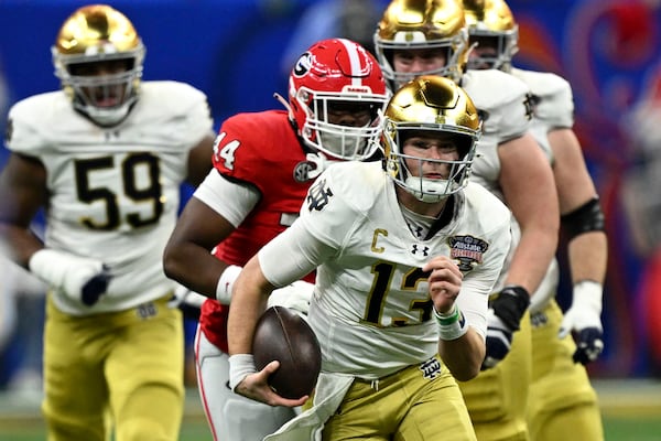 FILE - Notre Dame quarterback Riley Leonard (13) scrambles up field during the first half against Georgia in the quarterfinals of a College Football Playoff, Thursday, Jan. 2, 2025, in New Orleans. (AP Photo/Matthew Hinton, File)