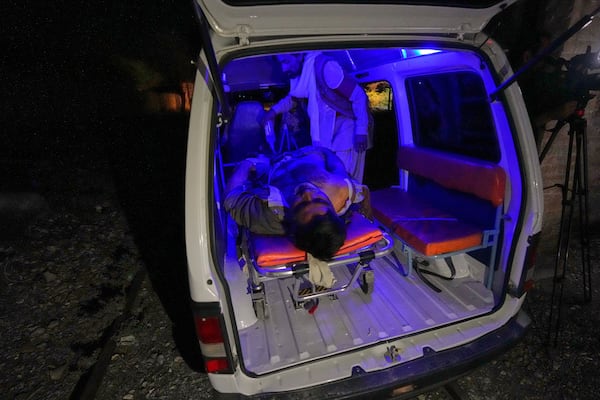 An injured passenger rescued by security forces from a passenger train attacked by insurgents is carried in an ambulance after arriving on a special train for injured and survivors organised by the army, at a railway station in Much, Pakistan's southwestern Balochistan province, Wednesday, March 12, 2025. (AP Photo/Anjum Naveed)