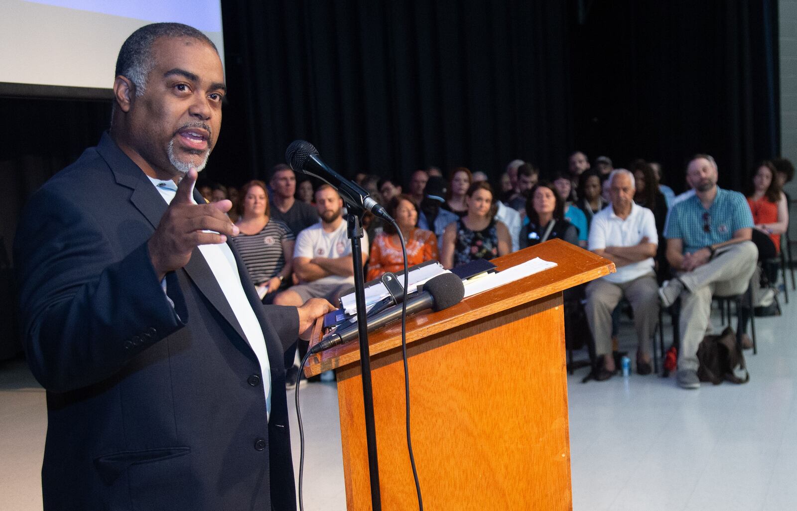 State Rep. Erick Allen, D-Vinings, talks to a packed house meeting to address concerns over toxic emissions at Campbell Middle School in Smyrna on Tuesday. (Steve Schaefer for the AJC)