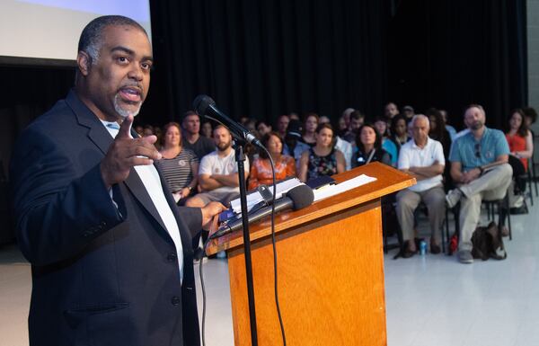 State Rep. Erick Allen, D-Vinings, talks to a packed house meeting to address concerns over toxic emissions at Campbell Middle School in Smyrna on Tuesday. (Steve Schaefer for the AJC)