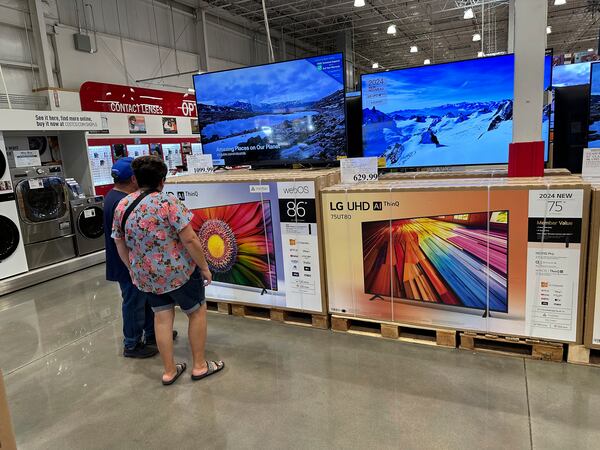 FILE - Shoppers consider big-screen televisions on display in a Costco warehouse Tuesday, Oct. 22, 2024, in Sheridan, Colo. (AP Photo/David Zalubowski, File)