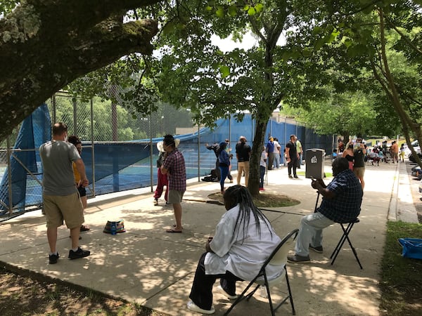 A socially distanced line outside the Joseph McGhee Tennis Center in southwest Atlanta. (VANESSA MCCRAY/AJC)