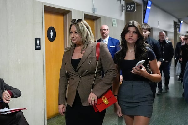 Krista Lee, left, ex-wife of Cash App founder Bob Lee, and other family members walk to Department 28 to enter the courtroom at the Hall of Justice for the murder trial of Nima Momeni, Monday, Dec. 2, 2024, in San Francisco. (AP Photo/Godofredo A. Vásquez)