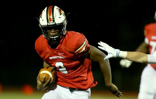 October 30, 2015 - Norcross, Ga: GAC running back Alex Rowe (2) runs against Lovett defensive back Chase Carter in the first half of their game at Greater Atlanta Christian Friday in Norcross, Ga., October 30, 2015. PHOTO / JASON GETZ