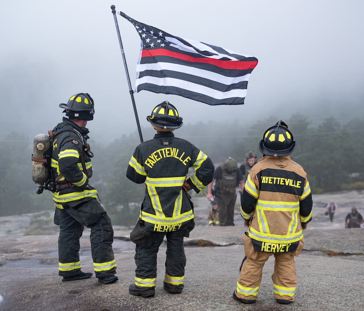 Fayetteville firefighters stand atop the final steep section of Stone Mountain to cheer on fellow firefighters Sunday morning, Sept. 11, 2022, during the annual remembrance of the 9/11 terrorist attacks. (Photo: Ben Gray for The Atlanta Journal-Constitution)