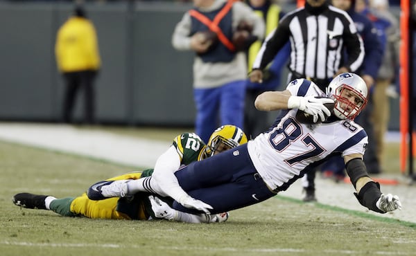 New England Patriots' Rob Gronkowski catches a pass in front of Green Bay Packers' Morgan Burnett during the first half of an NFL football game Sunday, Nov. 30, 2014, in Green Bay, Wis. (AP Photo/Tom Lynn) New England Patriots' Rob Gronkowski catches a pass in front of Green Bay Packers' Morgan Burnett, who played at Georgia Tech, during the first half of an NFL football game Sunday, Nov. 30, 2014, in Green Bay, Wis. (AP Photo/Tom Lynn)