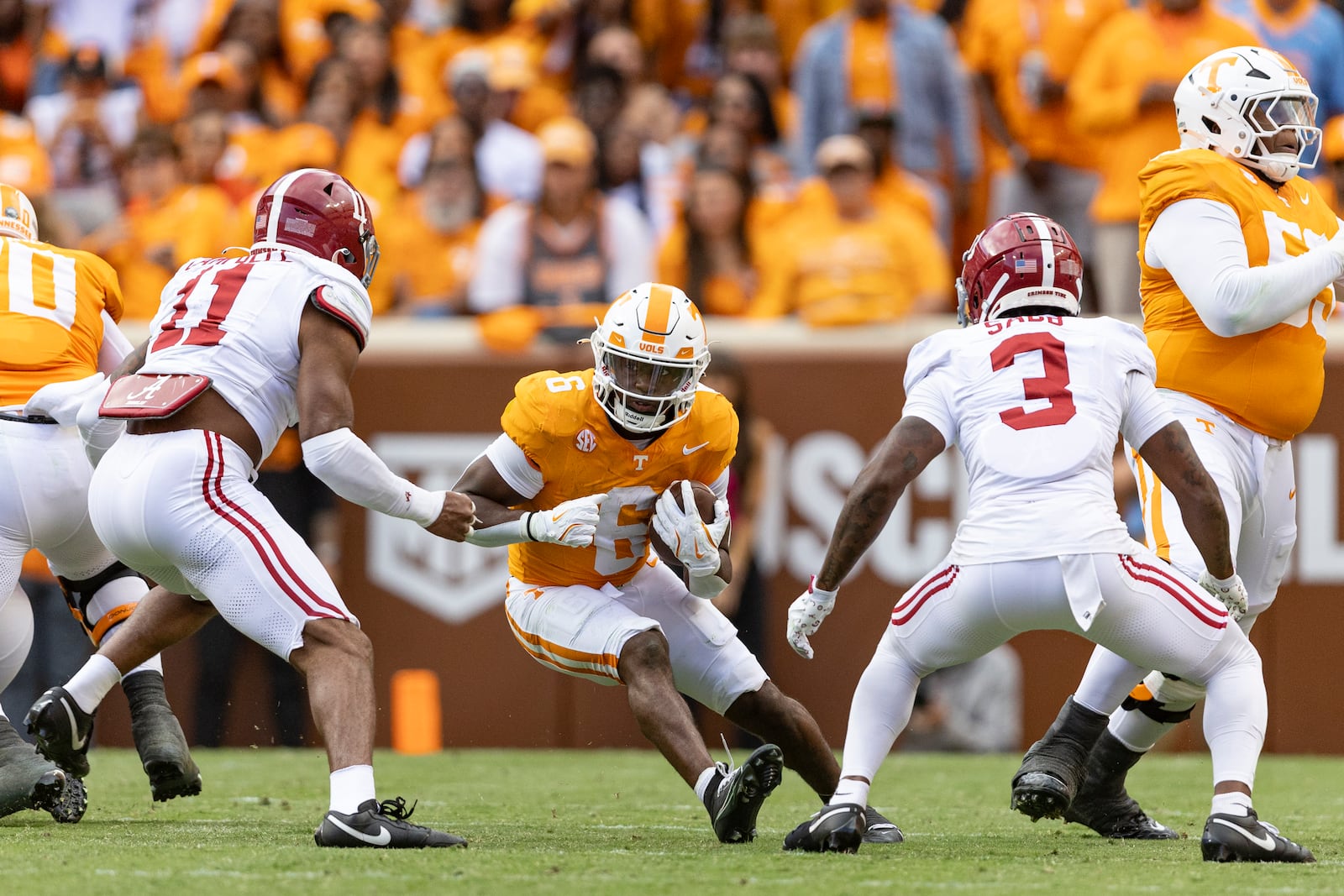 Tennessee running back Dylan Sampson (6) runs for yardage as he's chased by Alabama linebacker Jihaad Campbell (11), and defensive back Keon Sabb (3) during the first half of an NCAA college football game Saturday, Oct. 19, 2024, in Knoxville, Tenn. (AP Photo/Wade Payne)