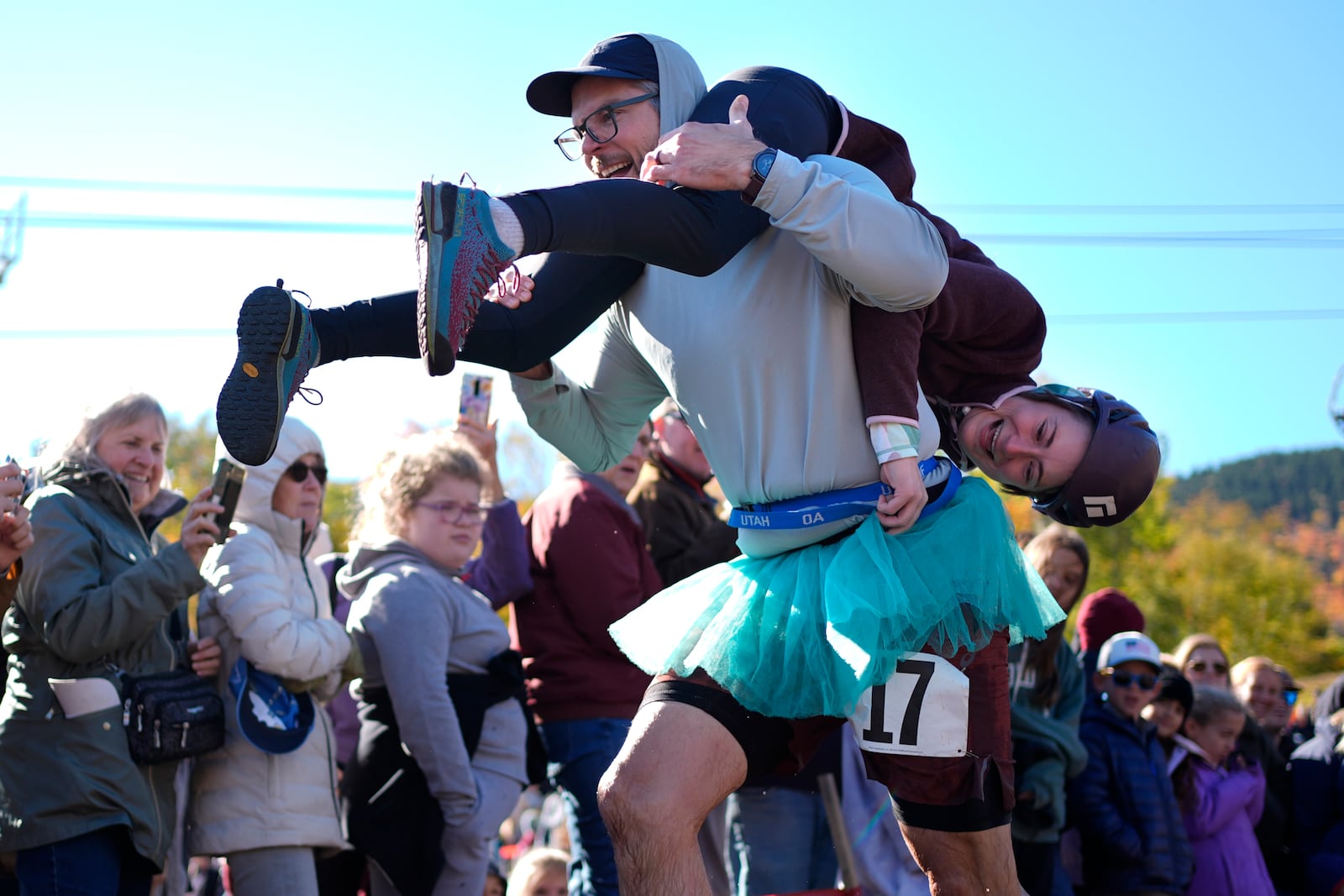 Galen Staats carries Amy Bannon during the North American Wife Carrying Championship, Saturday, Oct. 12, 2024, at Sunday River ski resort in Newry, Maine. (AP Photo/Robert F. Bukaty)