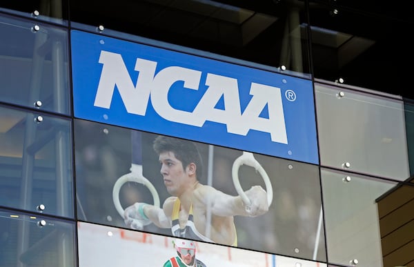 FILE - In this April 25, 2018, file photo, signage is displayed at the NCAA headquarters in Indianapolis. (AP Photo/Darron Cummings, File)