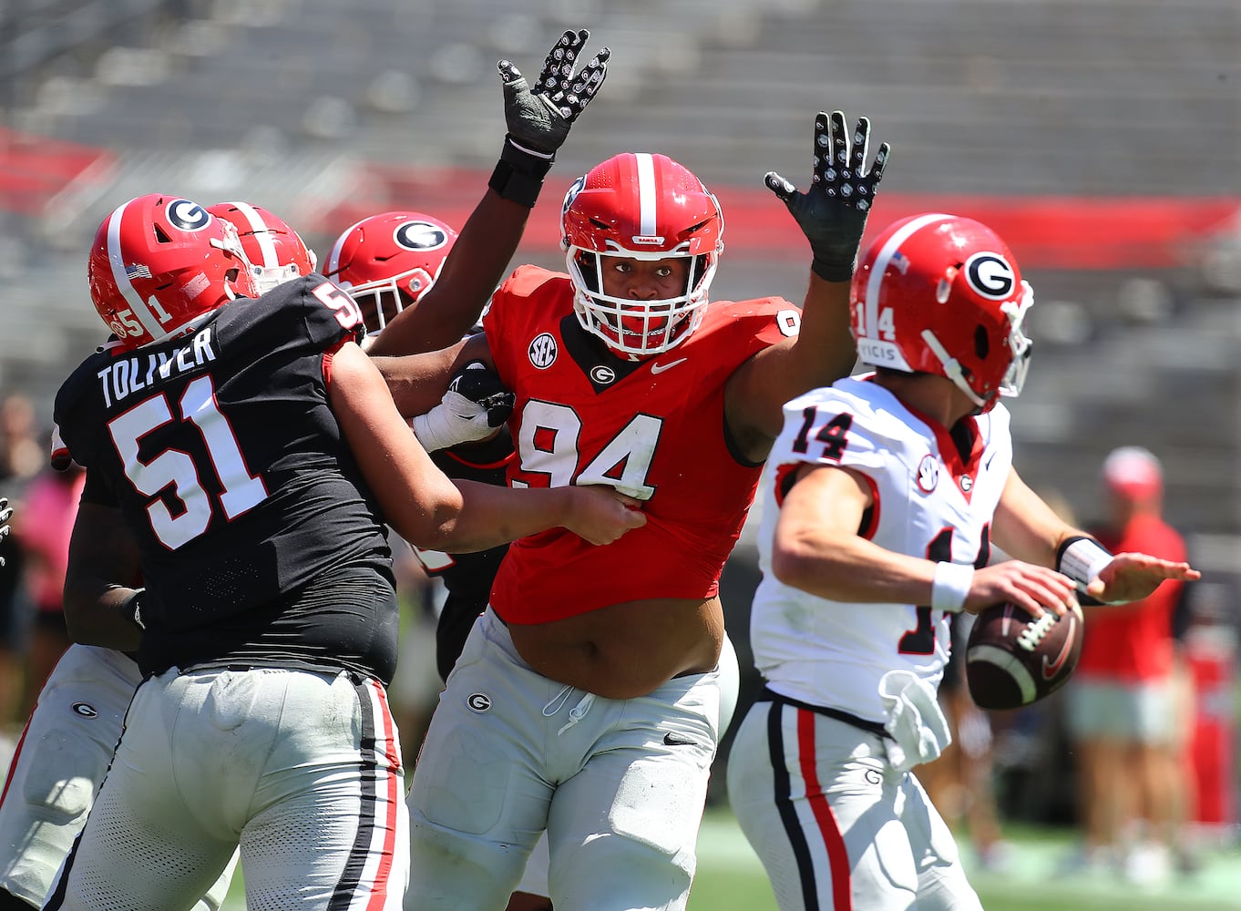 Defensive lineman Xzavier McLeod comes with the pressure against quarterback Gunner Stockton during the G-Day game on Saturday, April 13, 2024.  Curtis Compton for the Atlanta Journal Constitution