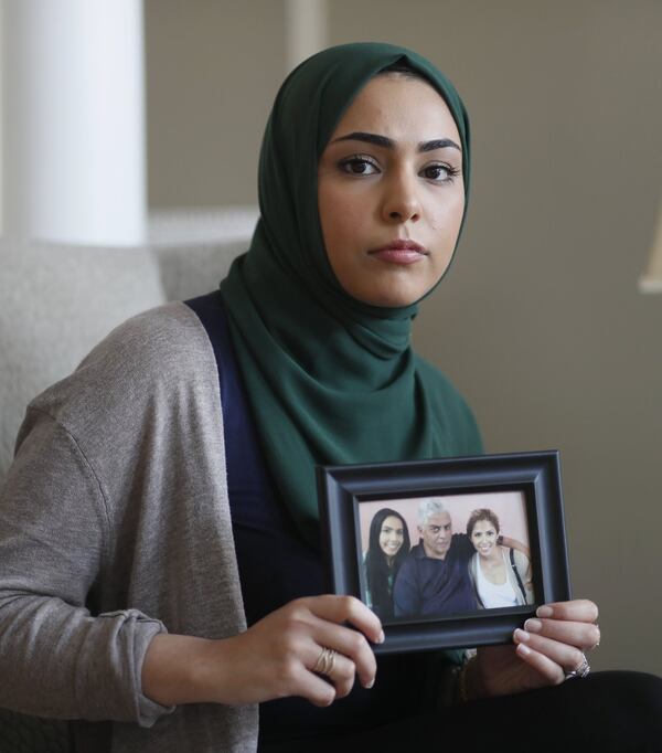 August 13, 2019, 2019 - Peachtree Corners - Mariam Slaibi holds a photo of her father. The Slaibi family lost their father to cancer last year. Now with the sterigenics plant, they wonder if there could be a connection. Bob Andres / robert.andres@ajc.com