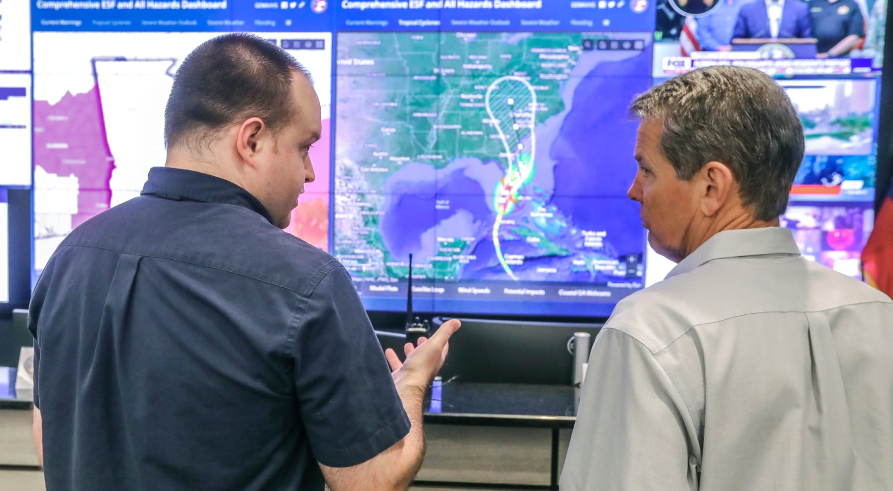 State Meteorologist Will Lanxton (left) explains the latest hurricane projections with Governor, Brian Kemp (right). Gov. Brian Kemp touring the GEMA facility on Wednesday, Sept. 28, 2022 urged Georgians to take caution as Hurricane Ian gains intensity off the western coast of Florida, threatening to bring torrential rain, dangerous storm surges and sweeping winds to the state this week.  (John Spink / John.Spink@ajc.com)

