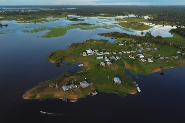 Homes are surrounded by water in the Lago do Soares village, in Autazes, Amazonas state, Brazil, Feb. 17, 2025. (AP Photo/Edmar Barros)