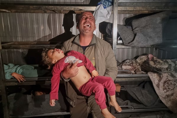 EDS NOTE GRAPHIC CONTENT.- A man holds the body of a dead child after Israeli airstrikes at the morgue of the hospital in Khan Younis, southern Gaza Strip, Tuesday March 18, 2025.(AP Photo/ Mohammad Jahjouh)