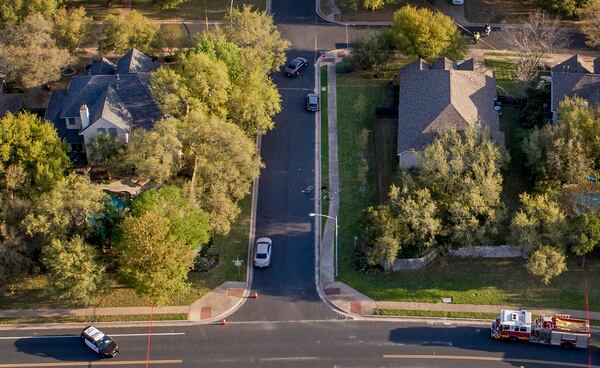 A bicycle remains in the middle of the street on Dawn Song Drive in the Travis Country neighborhood on Monday, the morning after a bomb exploded.  JAY JANNER / AMERICAN-STATESMAN