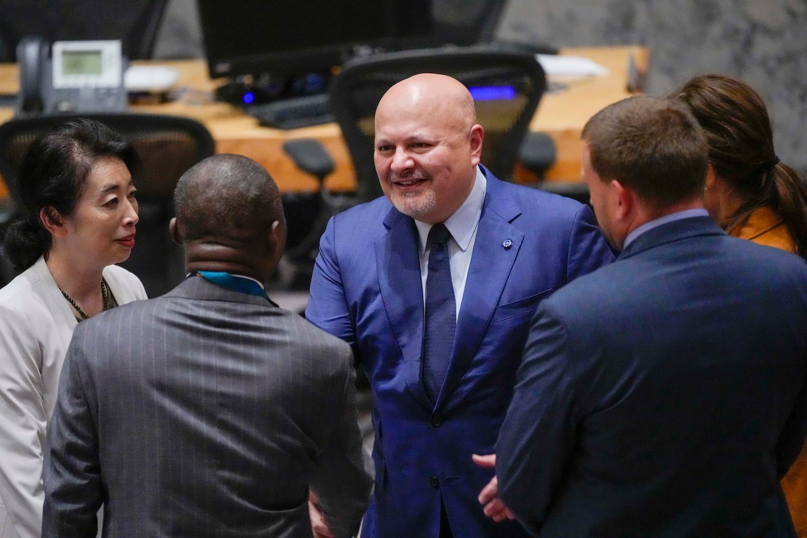 FILE - Karim Khan, center, prosecutor of International Criminal Court, greets members of delegations as he arrives for a Security Council meeting on the situation in Sudan, Thursday, July 13, 2023, at United Nations headquarters. (AP Photo/Mary Altaffer, File)