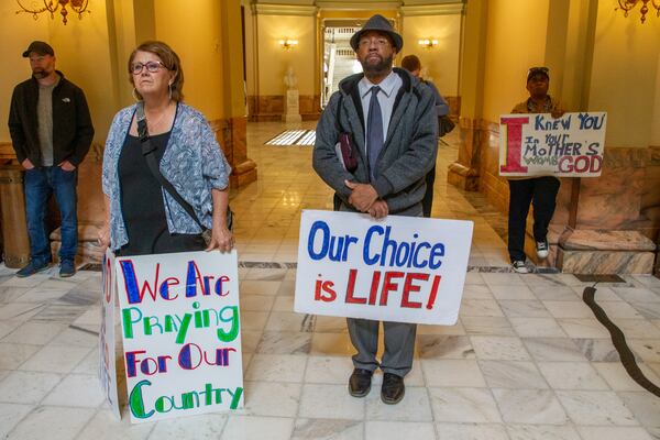 Donna Boyer (L), Brian Lawson, and Debora Rucker listen to the speakers during an anti-abortion press conference in the state capital Friday morning. (Steve Schaefer / steve.schaefer@ajc.com)