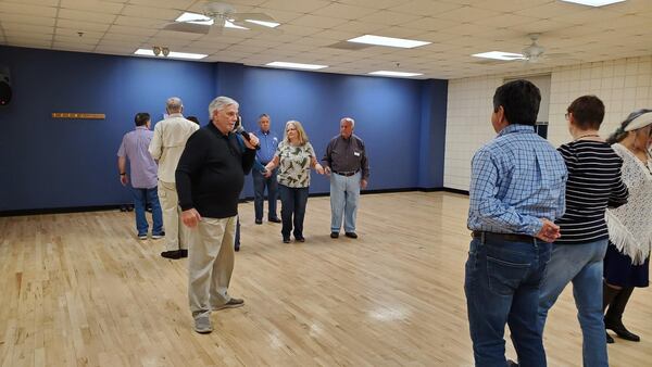 Dan Mitchell, the Peachtree Squares caller, calls a dance.