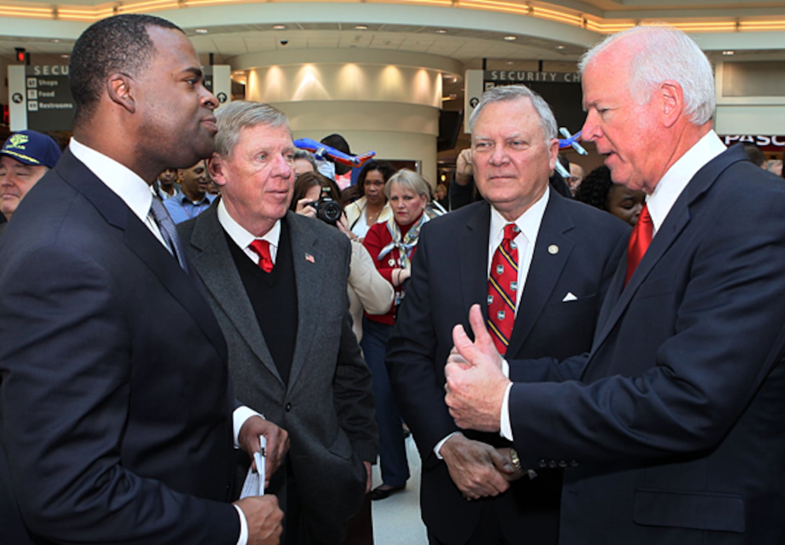 From left, Atlanta Mayor Kasim Reed, U.S. Sen. Johnny Isakson, Gov. Nathan Deal and U.S. Rep. Saxby Chambliss chat before a news conference on Monday Feb 13, 2012 officially celebrating the launch of Southwest airline's operations at Hartsfield-Jackson International Airport.