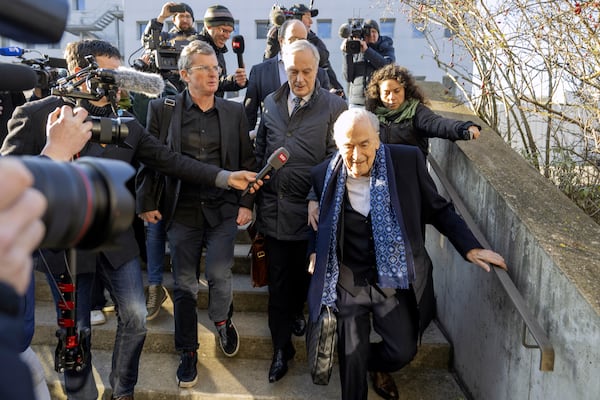 Ex-FIFA president Sepp Blatter, right, arrives in front of the Strafjustizzentrum Court of Kanton Basel-Landschaft in Muttenz, Switzerland, for his retrial on fraud, forgery and misappropriation charges Monday, March 3, 2025. (Urs Flueeler/Keystone via AP)