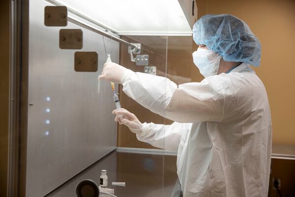 Floyd Medical Center pharmacy technician Jamison Christie prepares a dose of Monoclonal antibody treatment on Friday at Floyd Medical Center. (Ryan Smith photographer / Floyd Medical Center)