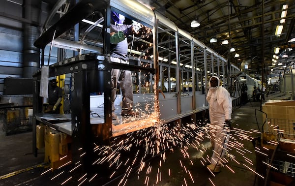 December 1, 2016 Fort Valley - Blue Bird Corporation workers work on the school bus assembly line at the company's headquarters in Fort Valley on Tuesday, December 21, 2016. Blue Bird Corporation is one of those venerable, rural manufacturers that produces the kind of jobs that Trump's core supporters are expecting him to produce. It has been through the wringer, but seems to be on the rise now -- good news for its little home town of Fort Valley. HYOSUB SHIN / HSHIN@AJC.COM