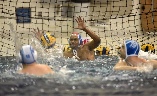 Members of the Rainbow Trout Water Polo team play a mini game during practice. (Hyosub Shin / Hyosub.Shin@ajc.com)