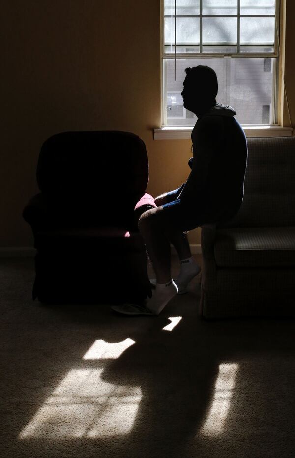 Jamil in his Decatur apartment. The Syrian former law student arrived in the U.S. on the same day as the terrorist attacks in Paris. BOB ANDRES / BANDRES@AJC.COM