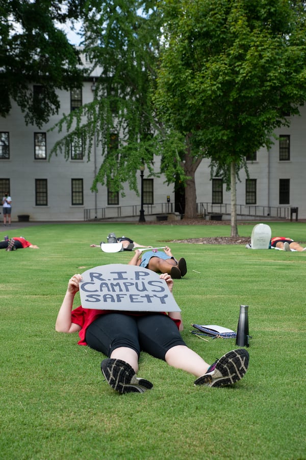 United Campus Workers of Georgia host die-in demonstration on the University of Georgia's north campus lawn outside of the Administration Building on Aug. 6, 2020 to protest UGA and the University System of Georgia's decision to reopen their campuses despite the onoging pandemic. Shira Chess, an Entertainment and Media Studies professor at UGA, holds a sign in the shape of a headstone and calls for "more autonomy" to be given to faculty and students. KYLE PETERSON FOR THE ATLANTA JOURNAL-CONSTITUTION