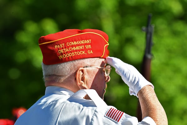 Retired Master Sgt. John Newport salutes during the funeral service for Howard Orr, a Navy veteran, at Georgia National Cemetery in Canton. (Hyosub Shin / Hyosub.Shin@ajc.com)