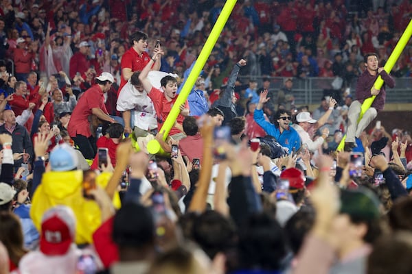 Mississippi fans celebrate by taking down a goal post after Mississippi defeated Georgia 28-10 at Vaught Hemingway Stadium, Saturday, November 9, 2024, in Oxford, Ms. (Jason Getz / AJC)
