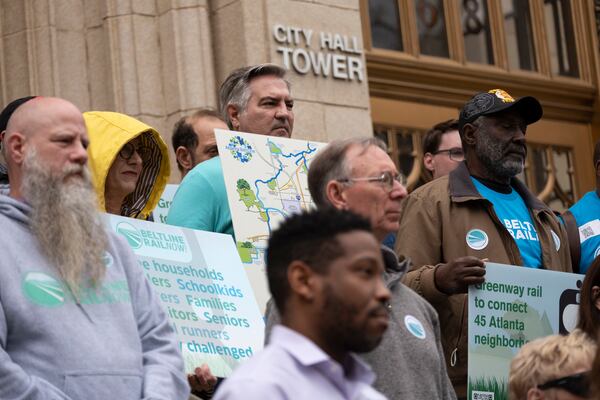 Advocates for Beltline rail, including Michael Fleming, center, rally on the steps of Atlanta City Hall on Friday, March 22, 2024.   (Ben Gray / Ben@BenGray.com)