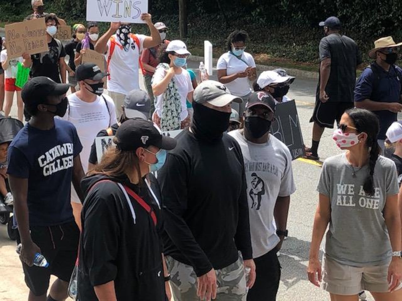 Falcons coach Dan Quinn and wife, Stacey (to his right), take part in a protest in Buckhead on Sunday, June 7, 2020.  D. Orlando Ledbetter/dledbetter@ajc.com)