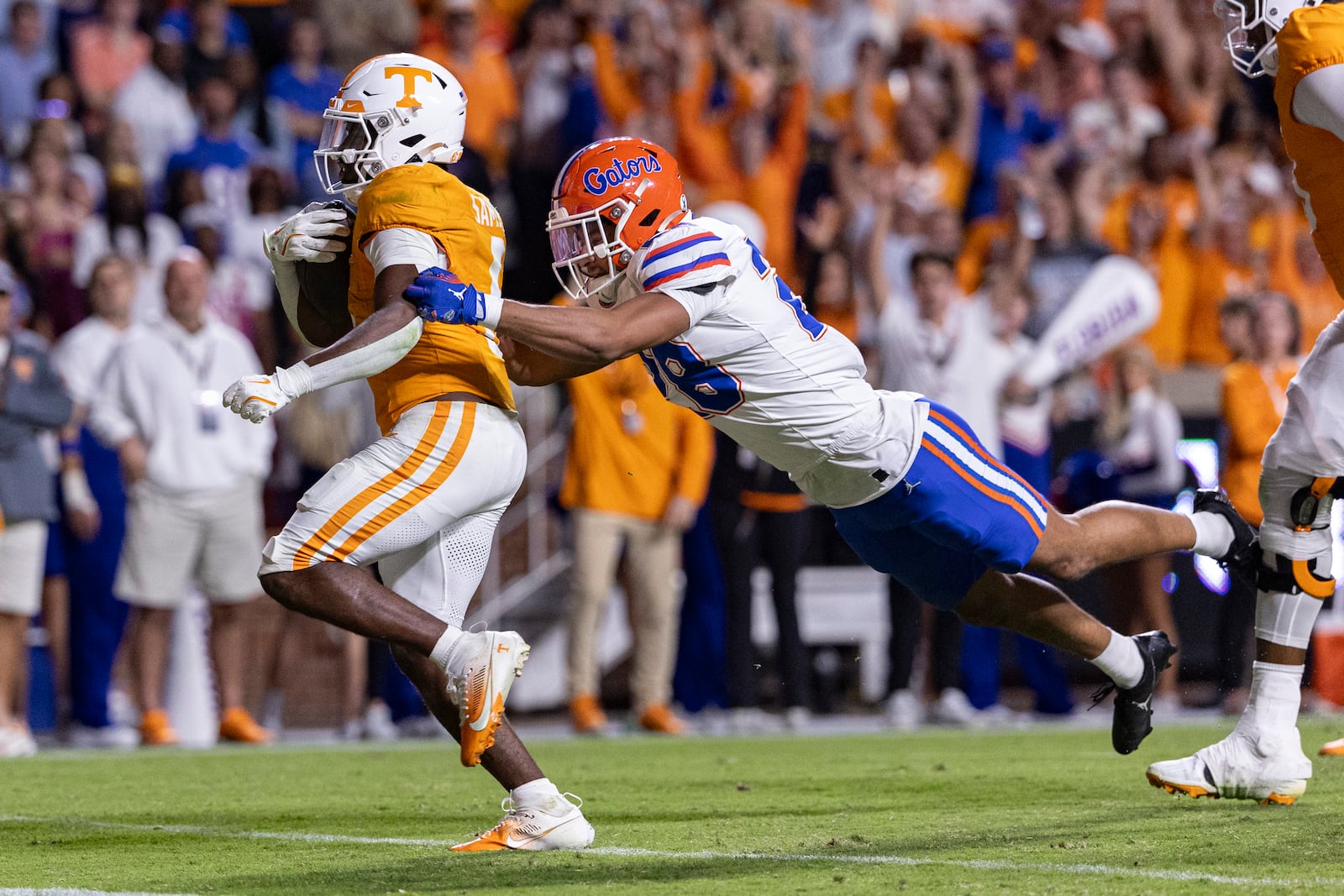 Tennessee running back Dylan Sampson (6) crosses the goal for a touchdown as he hit by Florida defensive back Devin Moore (28) during the second half of an NCAA college football game, Saturday, Oct. 12, 2024, in Knoxville, Tenn. (AP Photo/Wade Payne)