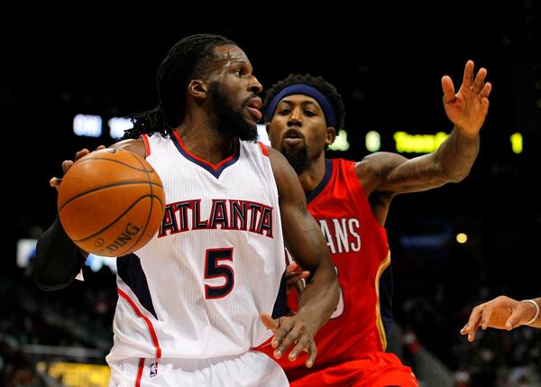 Atlanta Hawks forward DeMarre Carroll (5) drives against New Orleans Pelicans forward John Salmons (15) in the first period of an NBA basketball game in Atlanta, Friday, Nov. 28, 2014. The Hawks won 100-91. (AP Photo/Todd Kirkland)