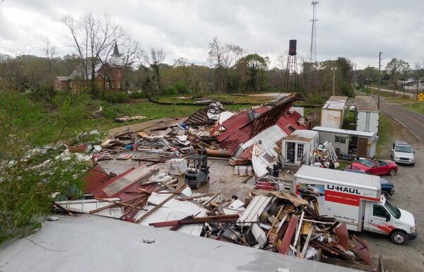 An aerial photograph shows the aftermath of the EF4 tornado that tore through the Newnan area. After making sure his family was safe, firefighter Jason Scott went back to work helping his neighbors.