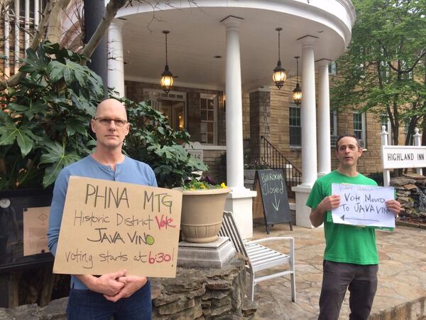 Poncey-Highland neighborhood residents Chuck Baker (left) and Greg Levin point the way to the election since the Highland Inn was off-limits because of the coronavirus. Photo by Bill Torpy