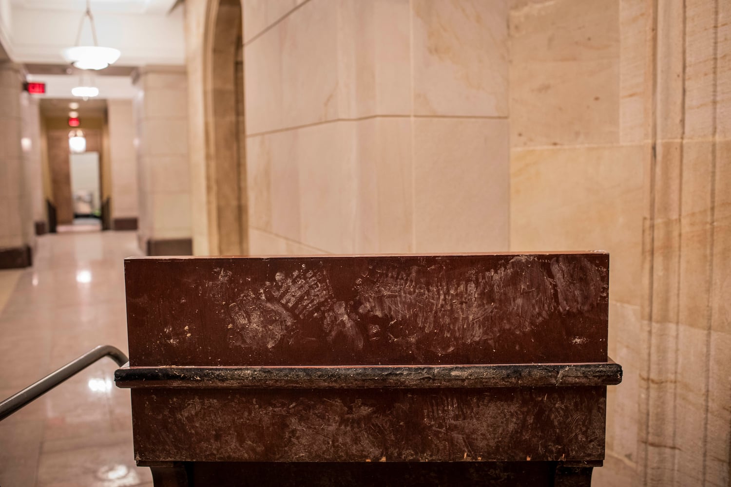 Footprints were left on a riot damaged display case at the Capitol in Washington on Thursday, Jan. 7, 2021. (Jason Andrew/The New York Times)