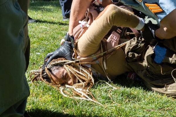 Police arrest pro-Palestinian protesters who set up an encampment at the Emory campus in Atlanta on Thursday, April 25, 2024. (Arvin Temkar / AJC)