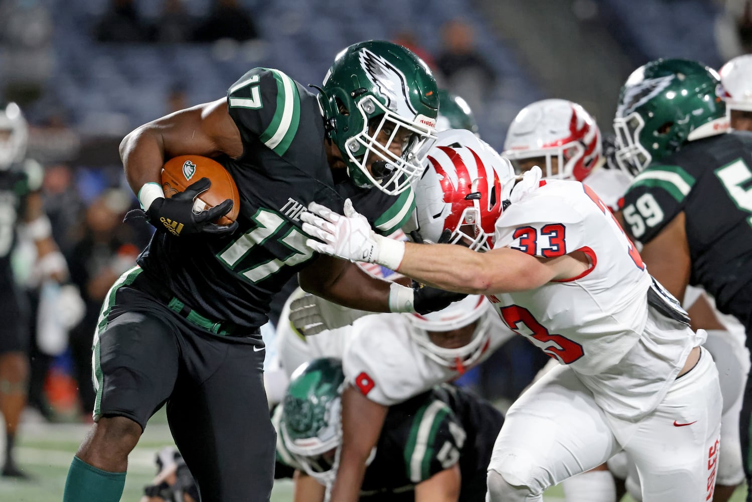 Collins Hill running back Ryan Stephens (17) runs against Milton linebacker Dylan Miller (33) during the first half of the Class 7A state title football game at Georgia State Center Parc Stadium Saturday, December 11, 2021, Atlanta. JASON GETZ FOR THE ATLANTA JOURNAL-CONSTITUTION