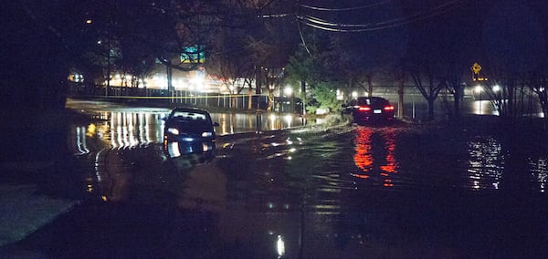 An abandoned car still stranded in flood waters near 631 Harwell Road in Northwest Atlanta on Monday. Heavy rains flooded streets & felled trees all around the Atlanta area.