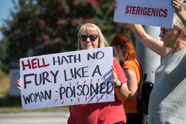 08/29/2019 -- Smyrna, Georgia -- Jenni Shover of Smyrna (center) holds a sign during a protest against a Cobb County Sterigenics plant at the intersection of Atlanta Road and Plant Atkinson Road, Thursday, August 29, 2019. (Alyssa Pointer/alyssa.pointer@ajc.com)