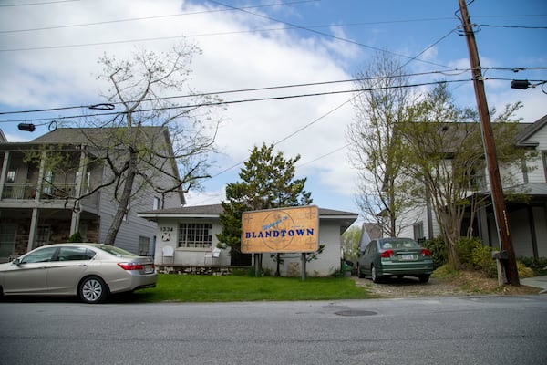 Turk’s studio, the exterior made of brick and concrete blocks, is surrounded by newly built single family homes in Blandtown community. The billboard outside of his property welcomes neighbors and visitors to an area that has changed greatly since he first moved in. (Alyssa Pointer / Alyssa.Pointer@ajc.com)