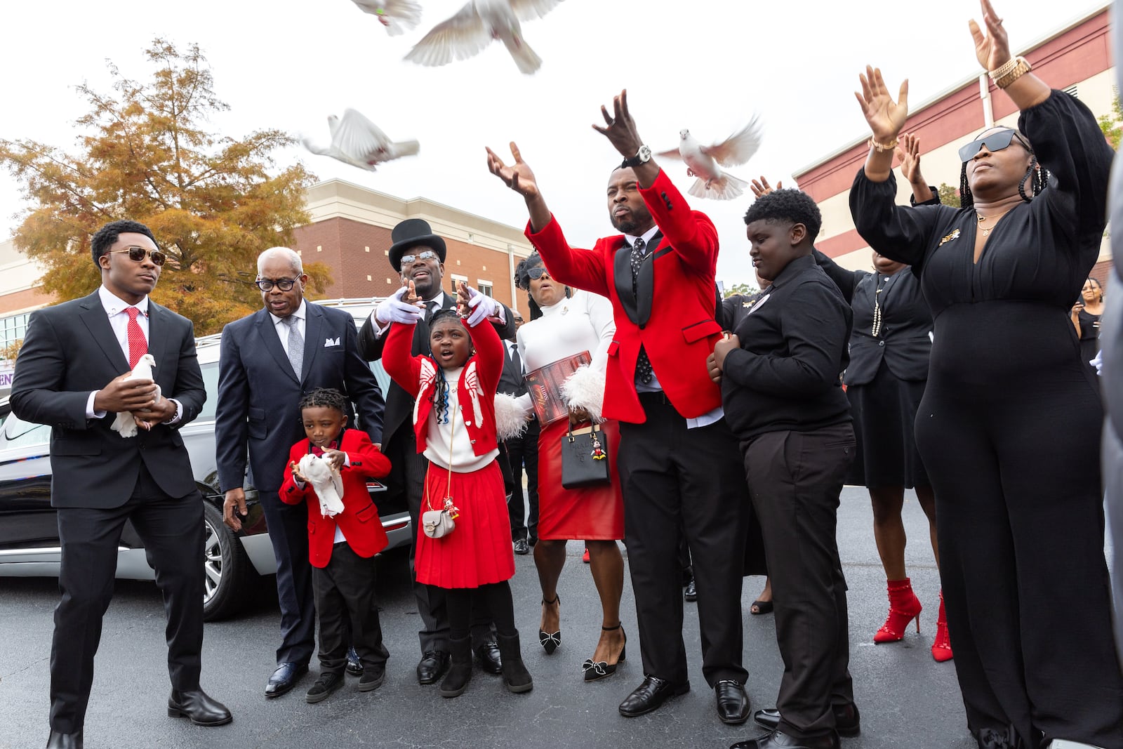 Family members and mourners release birds after radio host Wanda Smith’s funeral service at Word of Faith Cathedral in Austell on Monday, November 4, 2024. (Arvin Temkar / AJC)