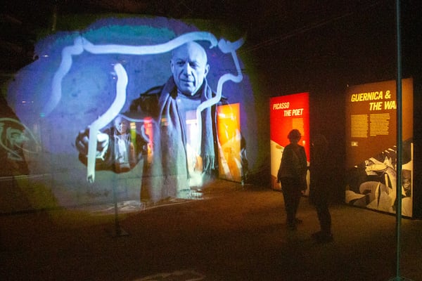 People look over the Imagine Picasso Atlanta: Immersive Art Exhibition on opening day at Pullman Yards in Atlanta Thursday, 17 2022.   STEVE SCHAEFER FOR THE ATLANTA JOURNAL-CONSTITUTION