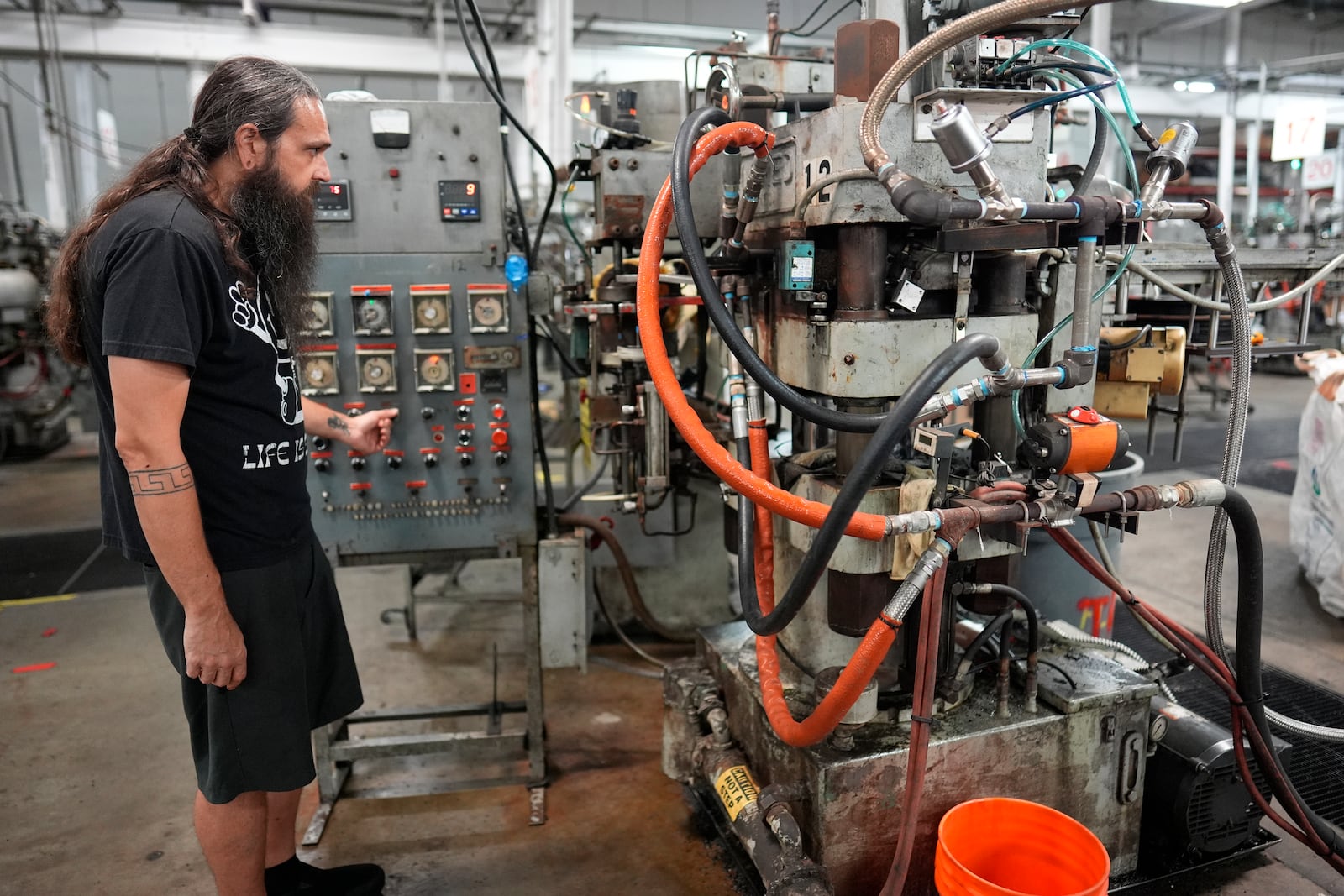 Chuck Springer operates a record pressing machine at the United Record Pressing plant July 11, 2024, in Nashville, Tenn. (AP Photo/George Walker IV)